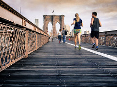2 people running on bridge